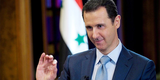 Donald Trump Syrian President Bashar Assad gestures during an interview in Damascus, Syria, in 2015.