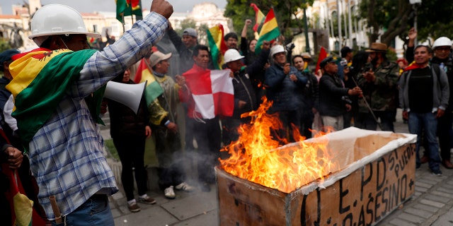 Opponents of Bolivia's former President Evo Morales celebrate after he announced his resignation in La Paz on Sunday. (AP Photo/Juan Karita)