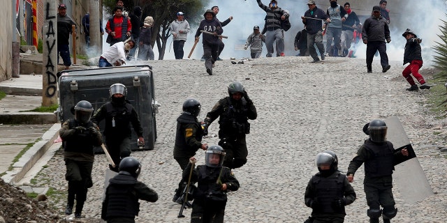 Supporters of former President Evo Morales clash with police in La Paz on Monday. (AP Photo/Juan Karita)