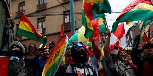 Anti-government protesters against the reelection of President Evo Morales gather just meters away from the presidential palace in La Paz, Bolivia, Saturday, Nov. 9, 2019. (AP Photo/Juan Karita)