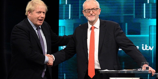 Johnson and Corbyn, shake hands during their election head-to-head debate. (AP)
