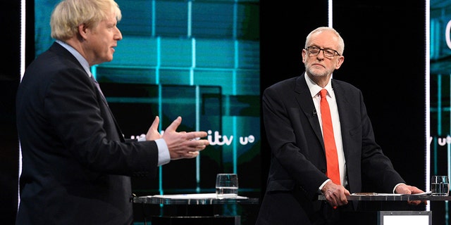In this photo issued by ITV, Jeremy Corbyn, right, and Boris Johnson, during the election head-to-head debate live on TV, in Salford, Manchester, England, on Tuesday. (AP/ITV)