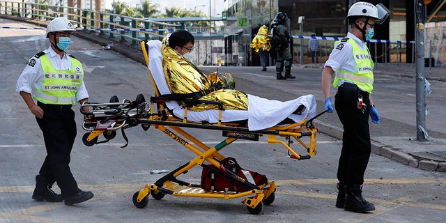A protester on a stretcher leaves the campus of Hong Kong Polytechnic University on Thursday. (AP)