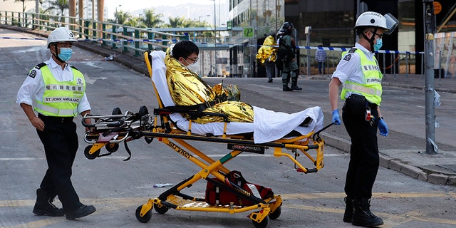 A protester on a stretcher leaves the campus of Hong Kong Polytechnic University on Thursday. (AP)