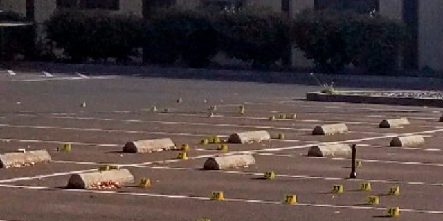 Crime scene evidence markers were placed in the parking lot of the Searles Elementary School where two boys were fatally shot early Saturday morning. (Union City Police Department via AP)