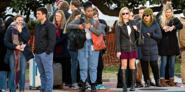 People wait near the U.S. Capitol and congressional office buildings Tuesday. (AP Photo/J. Scott Applewhite)