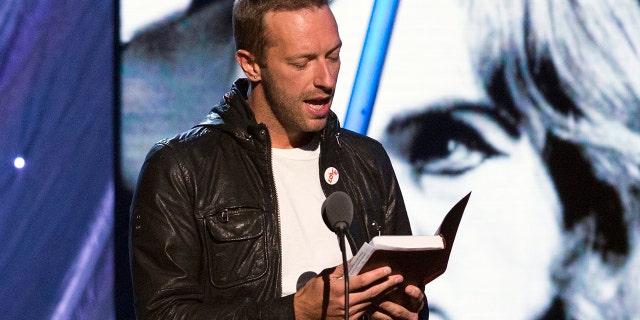 Coldplay lead vocalist Chris Martin reads from a Bible while inducting Peter Gabriel into the Rock and Roll Hall of Fame in 2014. REUTERS/Lucas Jackson