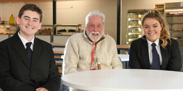 Cyril Aggett, pictured with students Harry Aldridge and Olivia Parsons, enjoys weekly lunches with students and staff at the school near his home.