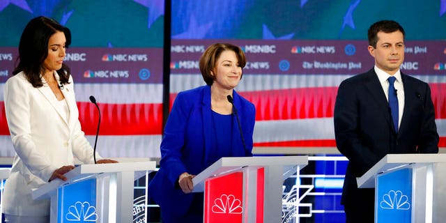 Democratic presidential candidates Rep. Tulsi Gabbard, D-Hawaii, Sen. Amy Klobuchar, D-Minn., and South Bend, Ind., Mayor Pete Buttigieg, from left, participate in a Democratic presidential primary debate, Wednesday, Nov. 20, 2019, in Atlanta. (AP Photo/John Bazemore)