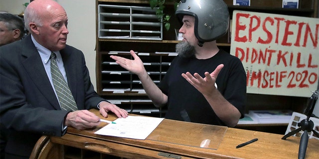 A candidate who called himself Rod Epstein Didn't Kill Himself Webber attempts to file to be listed on the New Hampshire primary ballot on Friday, in Concord, N.H. New Hampshire Secretary of State Bill Gardner, left, did not accept the application since he did not file using his legal name.