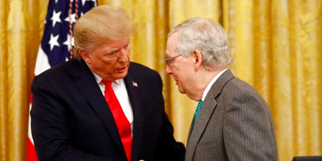 President Donald Trump shakes hands with Senate Majority Leader Mitch McConnell of Ky., in the East Room of the White House during an event about Trump's judicial appointments, Wednesday, Nov. 6, 2019, in Washington. (AP Photo/Patrick Semansky)