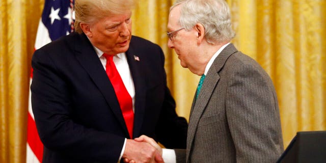 President Donald Trump shakes hands with Senate Majority Leader Mitch McConnell of Ky., in the East Room of the White House during an event about Trump's judicial appointments, Wednesday, Nov. 6, 2019, in Washington. (AP Photo/Patrick Semansky)