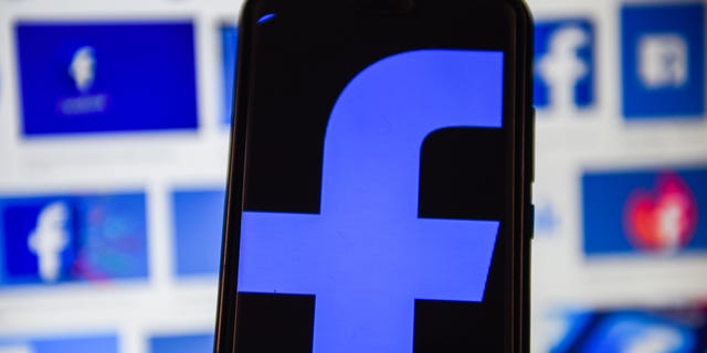 A Facebook logo is displayed on a smartphone. (Omar Marques/SOPA Images/LightRocket via Getty Images)