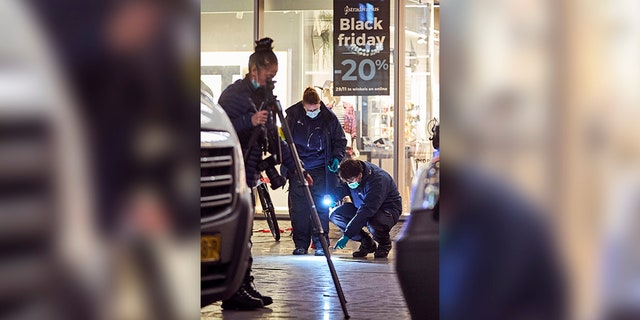 Forensic experts looked for clues on the scene of a stabbing incident in the center of The Hague, Netherlands, on Friday. Dutch police say multiple people have been injured in a stabbing incident in The Hague's main shopping street. (AP Photo/Phil Nijhuis)