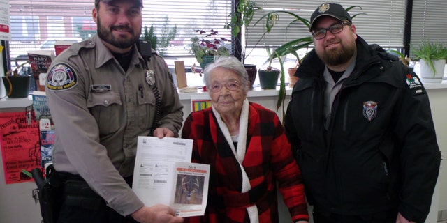 Florence poses with DNR Wardens after purchasing her first gun deer license.