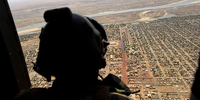 In this 2017 file photo, a French soldier stands inside a military helicopter during a visit by French President Emmanuel Macron to the troops of Operation Barkhane, France's largest overseas military operation, in Gao, northern Mali. (AP)