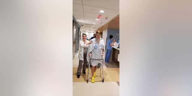 Phelps walks for the first time after a sudden cardiac arrest.