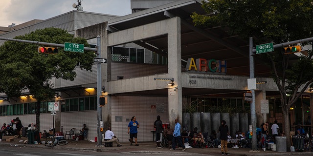 Homeless men and women are gathered outside of the Austin Resource Center for the Homeless in downtown Austin, Texas, on August 14, 2019. 