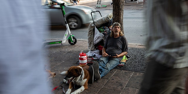 David Fields, who is homeless, sits on Sixth Street in Austin, Texas, on August 14, 2019.