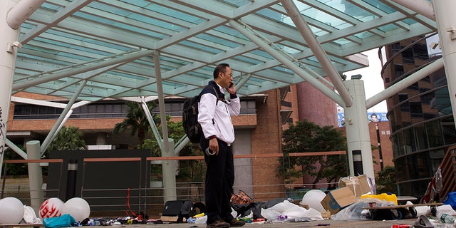 Professor Alex Wai, Vice President of Hong Kong Polytechnic University, takes in the vandalized campus as he leads a team of school officials and first aid providers to look for holed up protesters on a rooftop.