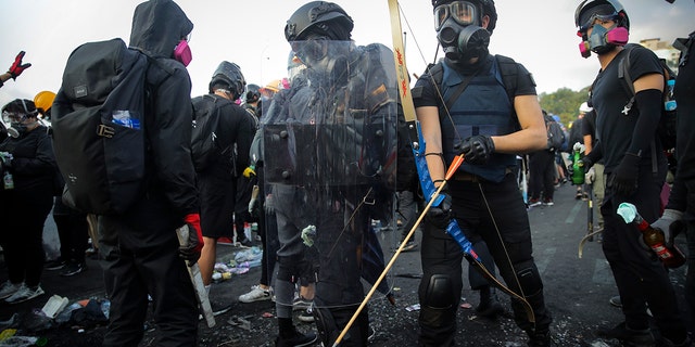 Students wielded homemade gear and weapons outside the Chinese University of Hong Kong on Wednesday.  (AP Photo/Kin Cheung)