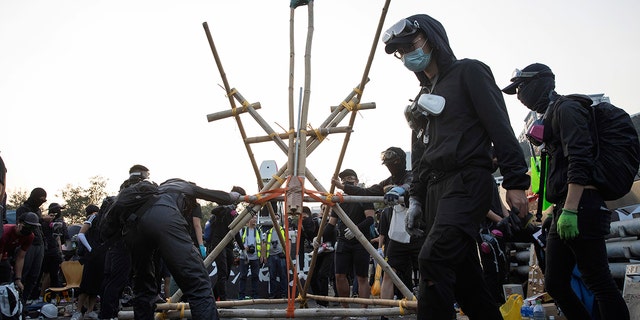 Protesters tested a self-made catapult on the barricaded bridge which leads into the Chinese University of Hong Kong on Wednesday. (AP Photo/Ng Han Guan)