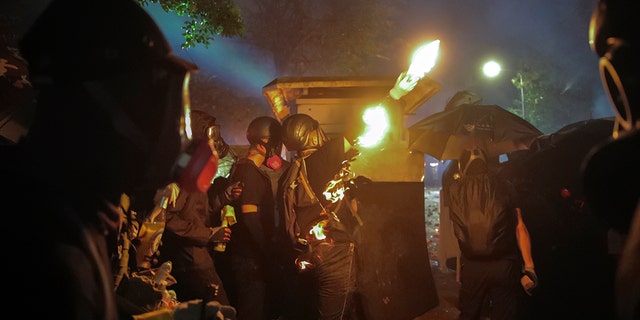 On Tuesday, police and protesters engaged in a day-long battled outside university campuses. Several thousand demonstrators also blocked roads as they took over a central business district. (AP Photo/Kin Cheung)