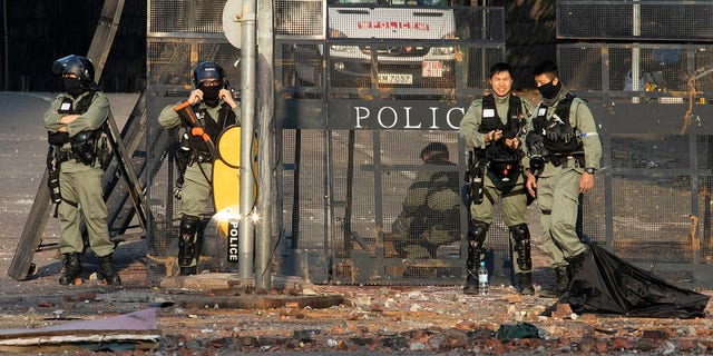 Police cordons off the Hong Kong Polytechnic University campus in Hong Kong on Tuesday, Nov. 19, 2019. (AP Photo/Ng Han Guan)