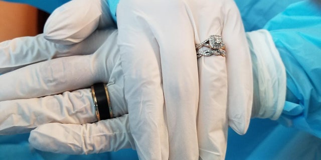 The couple had to wear gloves and surgical gowns at the ceremony.