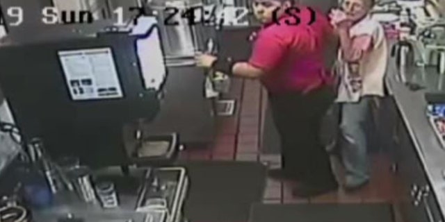 An additional camera captured another customer cowering in the kitchen of the pancake house behind an employee.