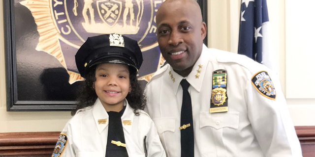 Ferni Balbuena at the 52nd precinct with Chief of Patrol Rodney Harrison