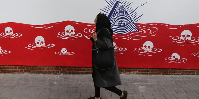 An Iranian woman walks past a new mural painted on the walls of the former US embassy in the capital Tehran on November 2, 2019. (Photo by ATTA KENARE / AFP) (Photo by ATTA KENARE/AFP via Getty Images)