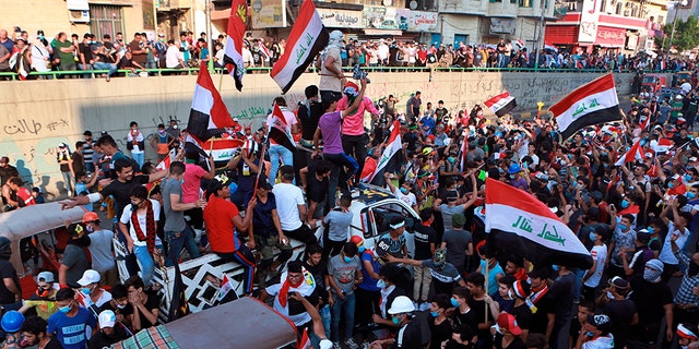 Anti-government protesters close downtown a street in Baghdad Wednesday.