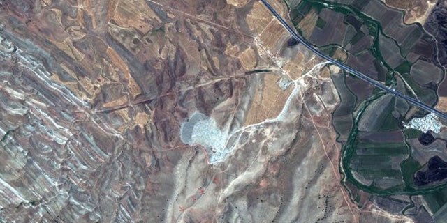 This satellite image was taken on July 31, 2019 by the WorldView-2 satellite. The red arrows show a surviving section of the Gawri Wall. (Credit: 2019 Maxar Technologies)