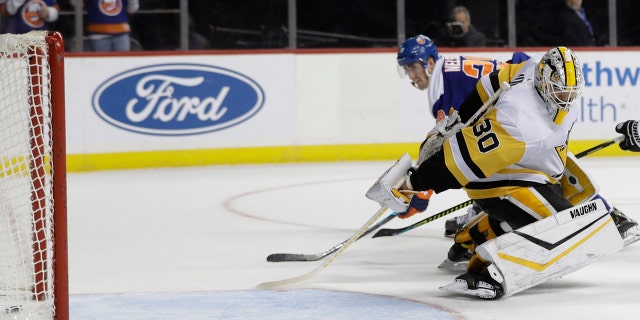 Pittsburgh Penguins goaltender Matt Murray (30) reacts as New York Islanders' Brock Nelson, left, scores a goal during the overtime period of an NHL hockey game Thursday, Nov. 21, 2019, in New York. The Islanders won 4-3. (AP Photo/Frank Franklin II)
