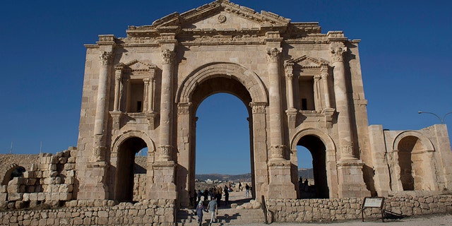 Tourists pass through the Arch of Hadrian, built during the Roman Empire, and the South Gate of the well preserved Ancient Roman city of Gerasa, in the city of Jerash, Jordan, in 2015.