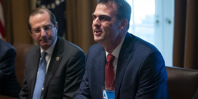 Kevin Stitt, then governor-elect of Oklahoma, right, speaks during a meeting with U.S. President Donald Trump in the Cabinet Room of the White House in Washington, D.C., U.S., on Thursday, Dec. 13, 2018. The state plans to release more than 400 inmates Monday in the largest one-day commutation ever. (Photographer: Al Drago/Bloomberg via Getty Images)