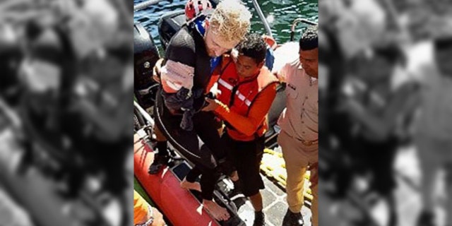 The 23-year-old, who was bitten on his forearm, managed to swim back to his boat after the shark attack, officials said.