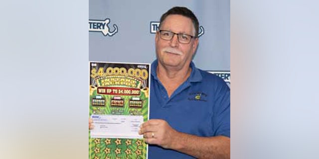 Rolf Rhodes but his million-dollar ticket at a gas station in Mendon, Mass.