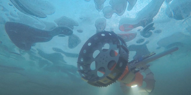 An underwater rover called BRUIE is being tested in Antarctica to look for life under the ice. Developed by engineers at NASA-JPL, the robotic submersible could one day explore ice-covered oceans on moons like Europa and Enceladus. BRUIE is pictured here in an arctic lake near Barrow, Alaska in 2015. (Credit: NASA JPL)