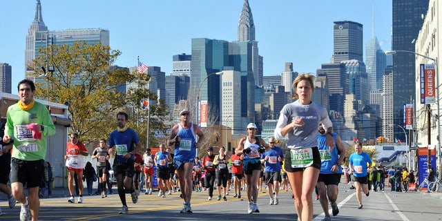 In this Nov. 6, 2011, file photo, runners make their way through the Queens borough of New York during the New York City Marathon.