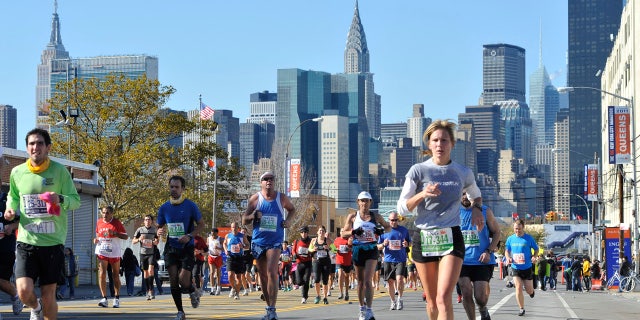 In this Nov. 6, 2011, file photo, runners make their way through the Queens borough of New York during the New York City Marathon.