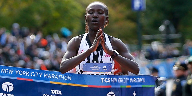 In this Nov. 2, 2014, file photo, Mary Keitany, of Kenya, puts her hands together as she breaks the tape after winning the elite women's division in the the 44th annual New York City Marathon in New York.