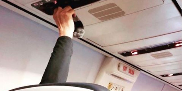 “Drying sweaty socks using the air vent,” text over the image of the passenger holding the socks read on Instagram.