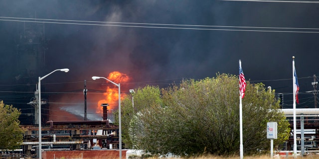 Smoke and fire are visible from the TPC Group Port Neches Operations explosion on Wednesday. (Marie D. De Jesus /Houston Chronicle via AP)