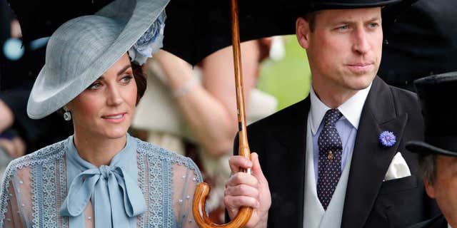 Catherine, Duchess of Cambridge and Prince William, Duke of Cambridge shelter under an umbrella as they attend day one of Royal Ascot at Ascot Racecourse on June 18, 2019, in Ascot, England. (Photo by Max Mumby/Indigo/Getty Images)
