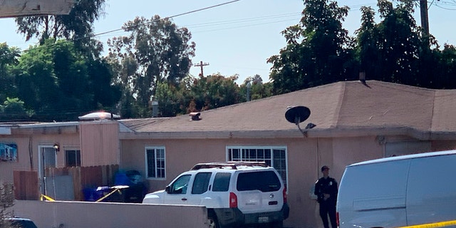 Police investigate the shooting scene Saturday. (Hayne Palmour/The San Diego Union-Tribune via AP)