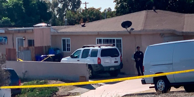 Police investigate the shooting scene Saturday. (Hayne Palmour/The San Diego Union-Tribune via AP)
