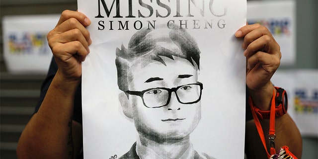 A supporter of Simon Cheng holds a poster outside of the British Consulate in Hong Kong in August during a rally in support of him. (AP)