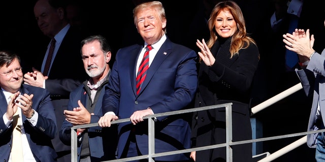 President Donald Trump watches the first half of an NCAA football game between Alabama and LSU with his wife Melania Saturday, Nov. 9, 2019, in Tuscaloosa, Alb. (AP Photo/John Bazemore)